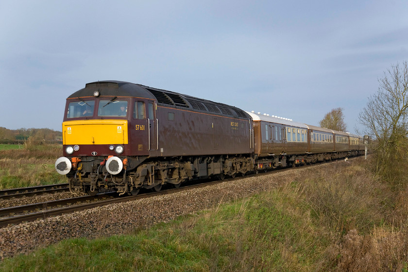 57601, outward leg of The Bath Christmas Statesman, 04.12 Aberystwyth-Bath (1Z82), King's Sutton 
 Thank goodness for the weak burst of sunshine that has just managed to illuminate the front and sides of West Coast's drab liveried 57601! The locomotive is leading the outward leg of Statesman Rail's charter to Bath that left Aberystwyth at an unearthly 04.12! Initially, the charter was piloted by departmental 97303 (formally 37178) as far as Shrewsbury due to it being fitted with ERTMS equipment enabling it to operate on the Cambrian line, something that the Class 57 could not do. The train is seen passing King's Sutton. 
 Keywords: 57601 The Bath Christmas Statesman 04.12 Aberystwyth-Bath 1Z82 King's Sutton West Coast Railways Statesman Rail