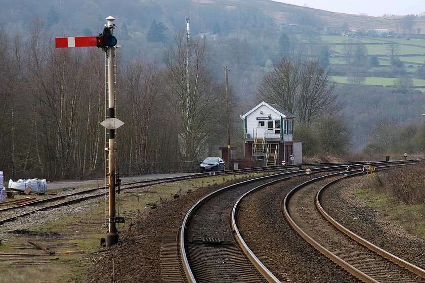 Grindleford signal box (LMS, 1938) 
 The Midland 1938 signal box at Grindleford is seen from the platform end of the station. It operates absolute block in both directions west to Earles and east to Totley Tunnel East through the length of the three and a half-mile tunnel with an intermediate block on the down to compensate for the losses of Hope and Bamford boxes. One refuge siding remains on the down side with the up sidings now being hopelessly overgrown to the right of the image. 
 Keywords: Grindleford signal box