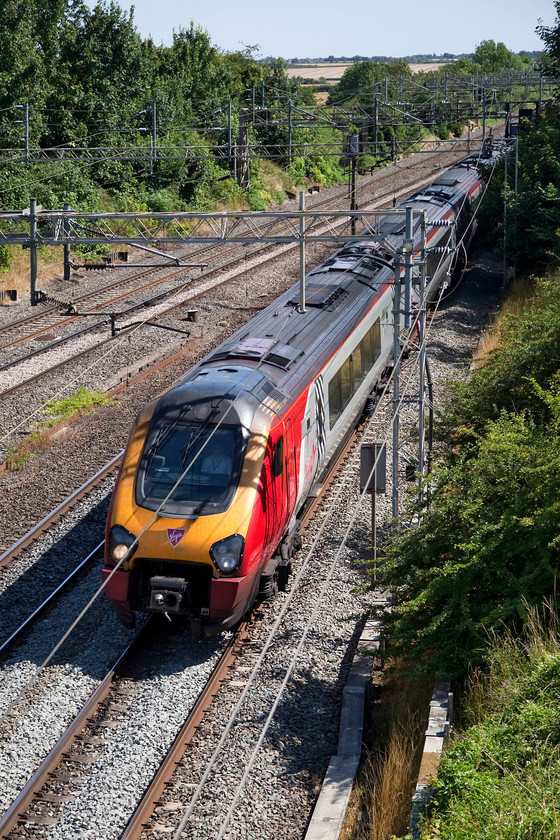 Class 222, VT 14.10 London Euston-Chester (1D88, RT), Victoria Bridge 
 A class 221 hurries down the WCML at Victoria Bridge between Milton Keynes and Northampton working the 14.10 Euston to Chester. For over one third of its journey this diesel unit is under 25kV overhead wires, not the best use of resources I would suggest. This is exactly the sort if service that would benefit a bi-mode powered train. 
 Keywords: Class 222 1D88 Victoria Bridge