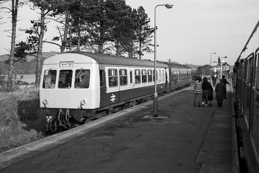 E50293 & E50265, 10.40 Middlesborough-Whitby & E50248 & E50543 10.13 Whitby-Midlesboorough, Battersby station 
 A busy scene at Battersby station as the up and down mid-morning services pass each other. The two-car Class 101 DMU to the left working the 10.40 Middlesborough to Whitby will leave second to the one to the right forming the 10.13 Whitby to Middlesborough. Once the two trains have departed and the signalman returns the arms to danger peace will then prevail for the next couple of hours or so in what is a pretty remote part of the North Yorkshire countryside. Today the signal box and semaphores are no more with No Signalman Token Remote (NSTR) in operation controlled by the drivers. I took an image of this in operation during my last visit with the driver standing at a point probably directly in front of me in this particular image, see.... https://www.ontheupfast.com/p/21936chg/26273785604/exchanging-token-142071-11-58-whitby 
 Keywords: E50293 E50265, 10.40 Middlesborough-Whitby E50248 E50543 10.13 Whitby-Midlesboorough, Battersby station Class 101 DMU first generation DMU