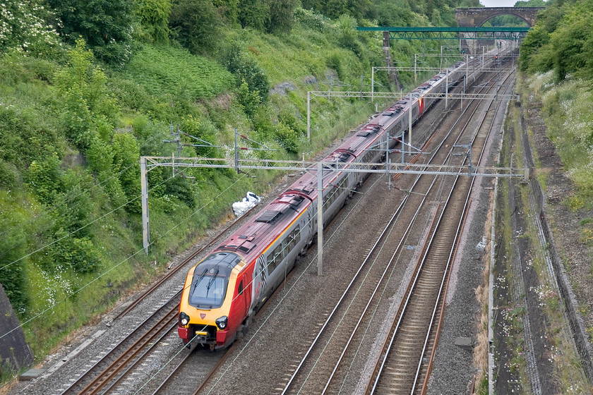 Class-221s, VT 05.50 Glasgow Central-London Euston (1M48), Roade cutting 
 A pair of Virgin Voyagers pass through Roade cutting with the first up Anglo Scottish express of the day that left Glasgow Central at 05.50. This must be an expensive train to run having to be double staffed being composed of two diesel-powered dmus! 
 Keywords: Class 221 05.50 Glasgow Central-London Euston 1M48 Roade cutting Virgin West Cast Voyager