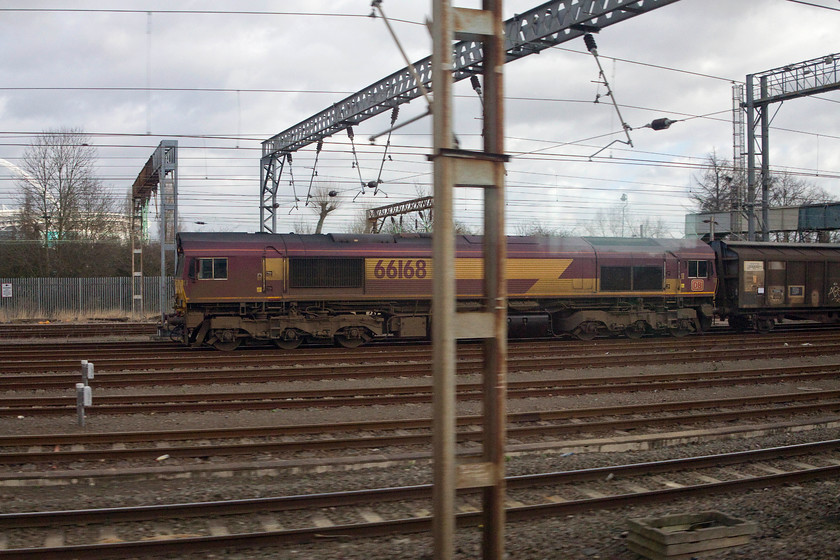 66168, 07.07 Dollands Moor-DIRFT (6M45), Wembley Yard 
 66168 waits at the north exit of Wembley Yard at the head of the daily 07.07 Dollands Moor to Daventry wagons full of continental bottle water. I always have my camera ready when we pass Wembley because you just never know what is going to be sitting there! 
 Keywords: 66168 07.07 Dollands Moor DIRFT 6M45 Wembley Yard