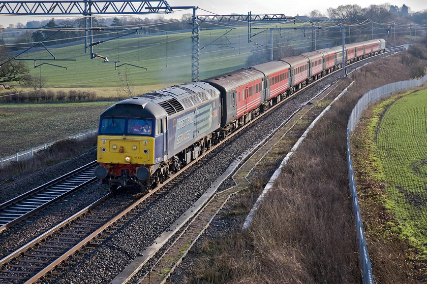 47810 & 47853, 09.40 Acton Reception Sidings-Crewe HS, Milton crossing 
 47810 'Peter Bath MBE 1927-2006' makes a fine sight as it comes around the curve on the exit from Roade cutting at Milton crossing. It is leading a motley collection of stock mostly in the former Virgin livery heading from Acton Reception sidings to Crewe where they will become part of the railtour strategic stock after being refurbished. At the rear of the train is 47853 
 Keywords: 47810 47853 09.40 Acton Reception Sidings-Crewe HS Milton crossing Peter Bath MBE 1927-2006 DRS Direct Rail Services