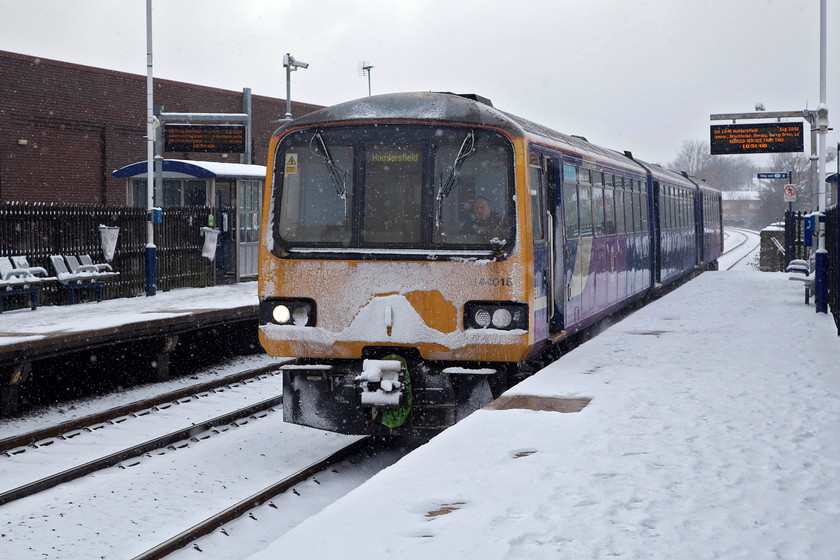 144018, NT 10.36 Sheffield-Huddersfield (2B42, 2L), Chapeltown station 
 144018 arrives at Chapletown station forming the 10.36 Sheffield to Huddersfield. After some overnight snowfall it was beginning to snow again, as can be seen from the front of the Pacer. Northern Rail made a good fist of it on this tricky day with most trains arriving on-time, this one was only two minutes into Huddersfield. 
 Keywords: 144018 2B42 Chapeltown station