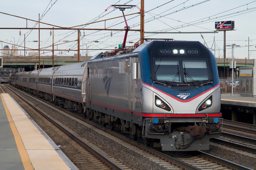 659, unidentified working, Newark International Airport station 
 An unidentified working heads away from New York passing through Newark International Airport station. The train is being led by one of Amtrak's new Siemens ACS-64 locomotives introduced last year, number 659. These European styled locos. were built at Siemens Sacramento facility are constructed on the EuroSprinter platform. So far, reliability has been good with them having a good future ahead. 
 Keywords: 659 unidentified working Newark International Airport station