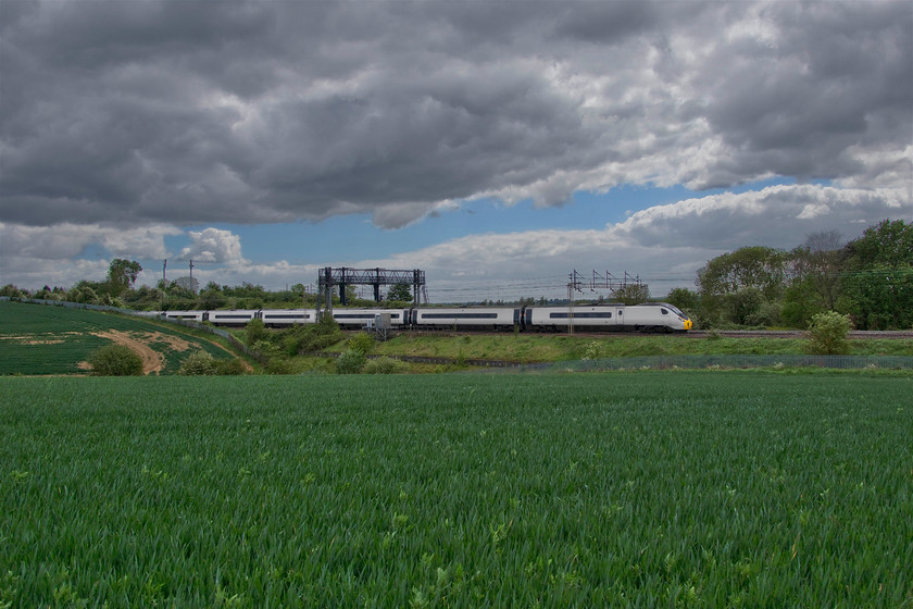 390009, VT 13.28 London Euston-Wolverhampton (9G08, 5L), between Roade & Ashton 
 The weather has changed quite dramatically! This time last week I was out walking in shorts and a T-shirt - now it's slacks, a sweater and my winter coat is out again! With a keen easterly wind blowing, a dramatic skyscape has created an interesting backdrop between Roade and Ashton as 390009 'Treaty of Union' heads north with the 13.28 Euston to Wolverhampton. 
 Keywords: 390009 13.28 London Euston-Wolverhampton 9G08 between Roade & Ashton Virgin Pendolino Avanti West Coast