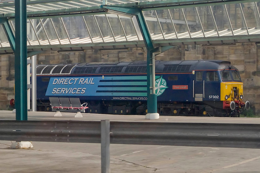 57302 stabled thunderbird, Carlisle station 
 Taken from through the train window as we entered Carlisle thunderbird 57302 'Chad Varah' is seen over on the far western side of the station. This locomotive is owned and operated by DRS and is only a short distance from their northern operation headquarters at the southern end of Kingmoor yard. 
 Keywords: 57302 stabled thunderbird Carlisle station Chad Varah Direct Rail Services DRS