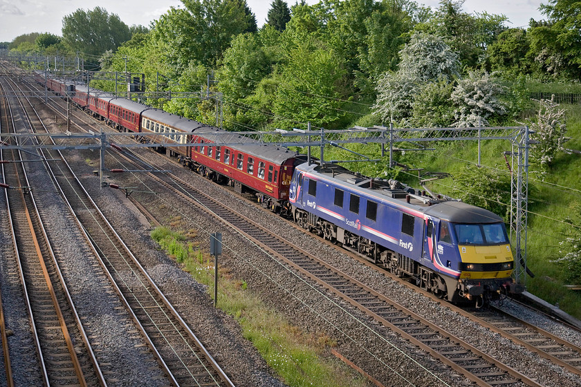 90019, outward leg of The Cumbrian Coast Express, 07.09 London Euston-Carnforth (1Z86), Victoria bridge 
 The Railway Touring Company's Cumbrian Coast Express charter heads north past Victoria bridge in Northamptonshire on a sunny late May morning. The train is led by 90019 that is taking a break from its more usual duties of hauling the sleeper services. Running as 1Z86 the charter left Euston at 07.09 and on arrival at Carnforth had former LMS Royal Scot 46115 'Scots Guardsman' attached to the front for a run around the delightful Cumbrian Coast route as far as Sellafield. 
 Keywords: 90019 The Cumbrian Coast Express 07.09 London Euston-Carnforth 1Z86 Victoria bridge The Railway Touring Company