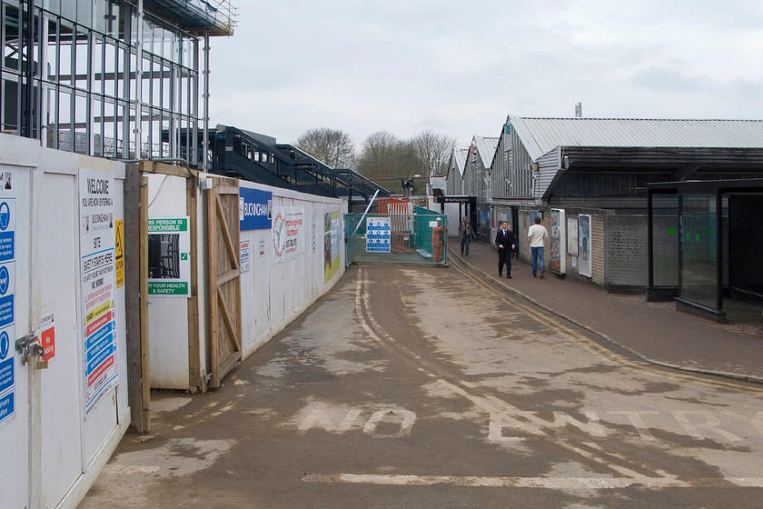 New station taking shape & old station, from ground floor level, Northampton station 
 Whilst construction of the new station at Northampton continues, the old one is very much still in use. Passengers now access the station down this narrow path that does get very congested at peak times. Over recent years the 1966 built station, designed by Ray Moorcroft described as 'three cowsheds bolted together' by Will Adams in his 2012 publication British Railways Past and Present book, has proved hopelessly inadequate hence yet another re-build! 
 Keywords: New station taking shape & old station, from ground floor level Northampton station