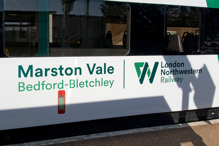 Vinyls, 230004, LN 09.17 Bletchley-Bedford (2S09, 1E), Bletchley station 
 London Northwestern has three Vivarail Class 230s for its operations on the Marston Vale line with any two in service on every one day. As can be seen in this photgraph, the units are branded as they are dedicated for use on the route between Bletchley and Bedford. This is the side of 230004 as it waits to leave Bletchley with the 09.17 to Bedford that Andy and travelled on throughout. 
 Keywords: Vinyls 230004, LN 09.17 Bletchley-Bedford 2S09 Bletchley station