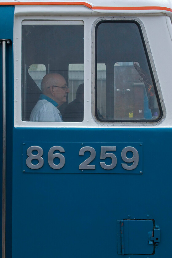 Les Ross, 86259, outward leg of The Cumbrian Mountain Express, 06.39 London Euston-Carlisle (1Z86, 9L), Rugby station 
 A familiar radio voice around the West Midlands for more years than he would want to admit, Les Ross sits in the cab of 'his' locomotive as it waits to leave Rugby. 86259 'Les Ross/Peter Pan' was leading the inaugural Cimbrian Mountain Express of the season that had left Euston at 06.39 heading for Carlisle running, as per usual as 1Z86. Thanks to privateer enthusiasts such as Les Ross we would not enjoy the sight of historic locomotives such as 86259 out on the mainline. 
 Keywords: Les Ross 86259 The Cumbrian Mountain Express 06.39 London Euston-Carlisle 1Z86 Rugby station AL6 Peter Pan