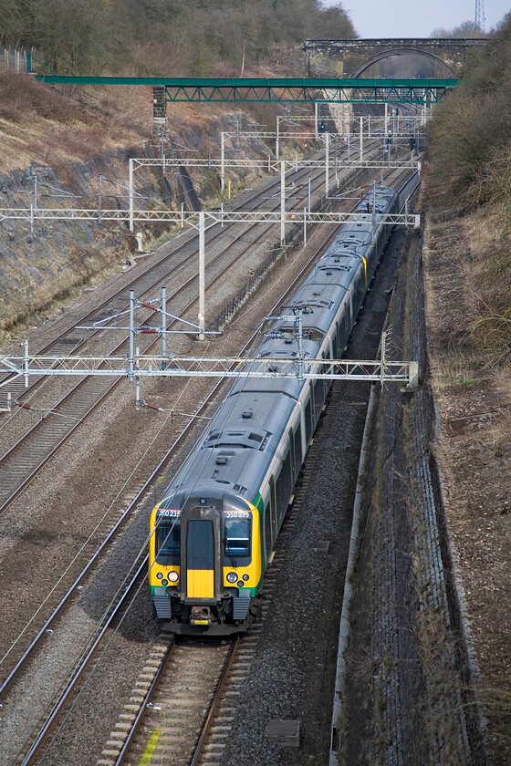 350235 & 350261, LM 10.08 Northampton-London Euston, Roade cutting 
 The 10.08 Northampton to Euston London Midland service passes through Roade cutting worked by 350235 and 350261. It was really pleasant to be standing at this spot with the spring sunshine on my back after what had been such a cold start to the moth so far. 
 Keywords: 350235 350261 10.08 Northampton-London Euston Roade cutting London Midland Desiro