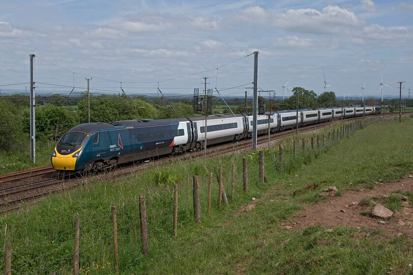 390131, VT 13.35 Glasgow Central-London Euston (1M14, 66L), Quintinshill Loops NY316694 
 The 13.35 Glasgow Central to Euston Avanti West Coast Pendolino is worked by 390131 'City of Liverpool' and is seen passing southwards (this is a 'going-away' shot) past Quintinshill loops. This is the exact spot where the worst British railway disaster occurred at 06.49 on 22.05.1915 that resulted in the deaths of two hundred and twenty-six passengers, mainly territorial soldiers from the 1/7th (Leith) Battalion, the Royal Scots who were heading off to fight at Gallipoli tragically not even making out of their own country. On this beautiful and clear summer's afternoon, the scene is very different to the absolute carnage and resultant inferno (that killed the majority of people) that ensued on that spring morning all those years ago. 
 Keywords: 390131 13.35 Glasgow Central-London Euston 1M14 Quintinshill Loops NY316694 Avanti City of Liverpool West Coast Pendolino