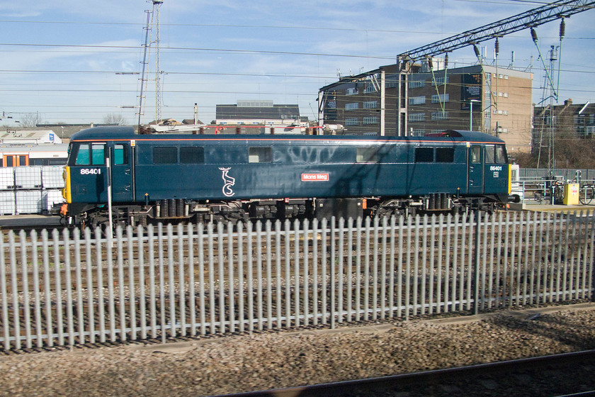 86401, stabled, Willesden Yard 
 In its newly applied Caledonian Sleeper livery, 86401 'Mons Meg' sits between duties at Willesden Depot. This vintage AC electric is used to haul ECS sleeper stock in and out of Euston. On rare occasions, it has been used to haul the services throughout when the regular locomotives are not available. 
 Keywords: 86401 Willesden Yard