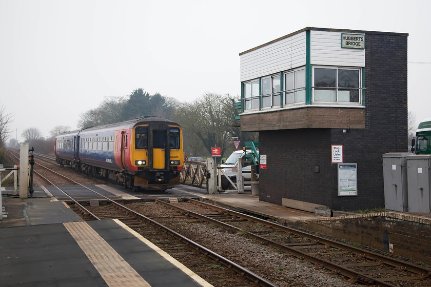 156401, EM 10.45 Nottingham-Skegness (2S13, 2E), Hubberts Bridge station 
 As we about to leave and head on to Boston, the signalman emerged from the warmth of Hubberts Bridge box to close the gates to the B1192 road. After a short wait, 156401 passed working the 2S13 10.45 Nottingham to Skegness. This service takes a real cross-country route including a reversal at Grantham. It also passes through a number of block posts controlled by traditional semaphores and 'proper' signal boxes! 
 Keywords: 156401 2S13 Hubberts Bridge station