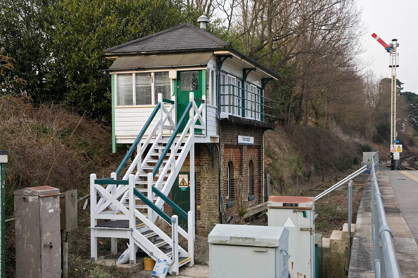 Pulborough sIgnal box (LBSC, 1878) 
 The attractive Pulborough signal box seen at the northern end of the up platform. The box is a superb and relatively unmolested example of a Type 5 London Brighton & South Coast Railway box that was opened in 1878. Apart from the steps being realigned and an enlarged porch (that contains personal needs facilities) the box is as-built down to the LBSC twenty-nine lever frame. Closure will be coming soon as this small section of absolute block signalling is to be abolished over the next year or so.

NB This box was to close on 16.03.2014 just over a year after this photograph was taken (added June 2024) 
 Keywords: Pulborough sIgnal box LBSC 1878