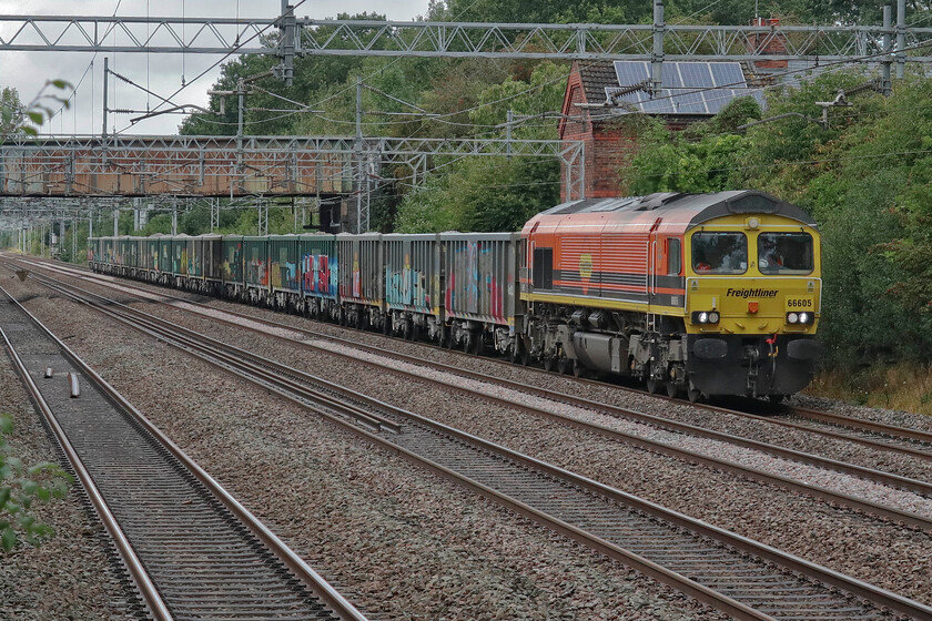 66605, 07.55 Tunstead Sidings-Northampton Castle Yard (6B71, 13E), Cathiron SP4667783 
 The 6B71 Tunstead to Northampton Castle Yard is not a working that I have many images of as it arrives from the north and I am south of Northampton. When it ran as 6M92 Andy I caught it between Crewe and Stafford back during the Covid year of 2021, see.... https://www.ontheupfast.com/p/21936chg/30018777695/x66757-09-15-tunstead-northampton Today 66705 is hauling the train and is seen passing Caithorn a short distance north-west of Rugby on the Trent Valey route. 
 Keywords: 66605 07.55 Tunstead Sidings-Northampton Castle Yard 6B71 Cathiron SP4667783