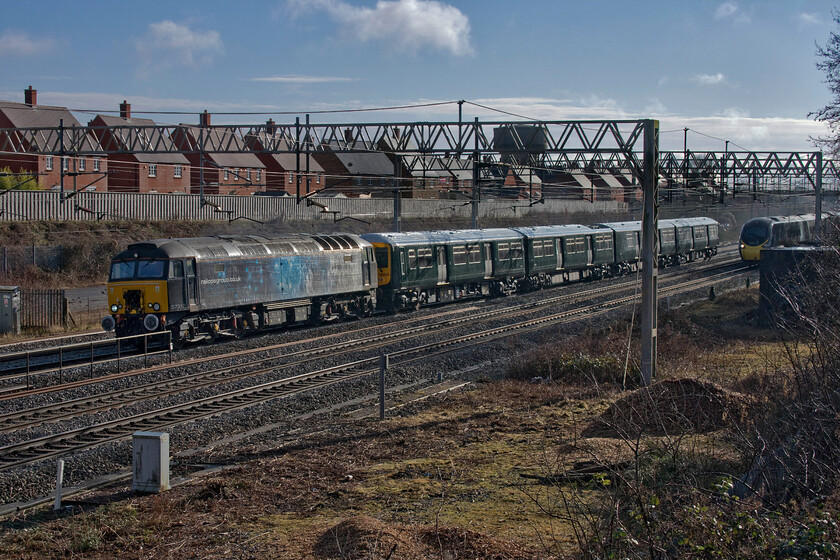 57312 & 769936, 10.42 Wolverton Centre Sidings-Reading Traincare Depot (5Q74, 12E) & 390131, VT 10.21 London Euston-Manchester Piccadilly (1H18, 1L), site of Roade station 
 Rather than travelling 'home' by heading south from Wolverton former Thameslink Class 319 769936 is dragged north to head south again after completing a southerly tour of Birmingham! Rail Operations Group have been contracted to undertake the drags of the units with 57312 leading with the ensemble passing through Roade as the 5Q74 10.42 Wolverton Works to Reading Traincare Depot on this ocassion. The Class 769s have been comprehensively re-built for bi or even tri-mode operation with GWR ordering nineteen for use in the Thames Valley as far as Oxford and for third rail services to Gatwick Airport. As can be seen to the right, 390131 'City of Liverpool' nearly spoilt the photograph fast approaching working the 10.21 Euston to Manchester service. 
 Keywords: 57312 769936, 10.42 Wolverton Centre Sidings-Reading Traincare Depot (5Q74, 12E) & 390131 VT 10.21 London Euston-Manchester Piccadilly (1H18, 1L), site of Roade station City of Liverpool