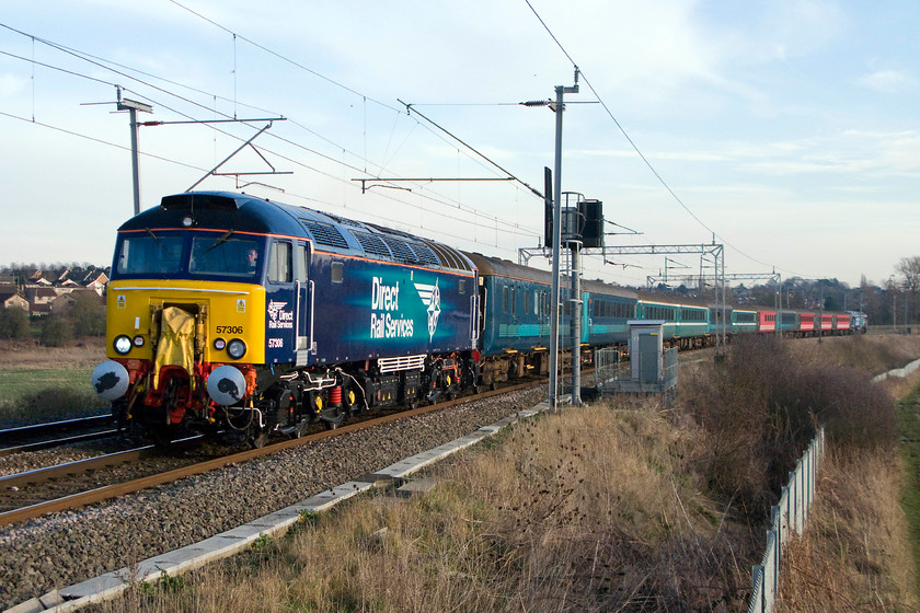 57306, 13.14 London Euston-Liverpool Lime Street footex (1Z53), Wilson`s crossing 
 Looking very smart in its DRS compass livery, 57306 passes Wilson's Crossing near Northampton leading the 13.14 Euston to Liverpool Lime Street football excursion. The stock is a complete mish-mash of Mk. II air conditioned coaches with 57309 'Pride of Crewe' on the rear. I am not at all sure why this footex was running as I can find no record football matches taking place involving either Liverpool or Everton on this particular Tuesday. If anybody can help me with any details of this train I would appreciate it. 
 Keywords: 57306 13.14 London Euston-Liverpool Lime Street footex (1Z53) Wilson`s crossing