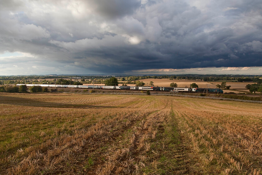 390112 VT, 15.47 Liverpool Lime Street-London Euston (1A53, 7L), Blisworth 
 This dramatic scene was recorded at the end of an afternoon of strong sunshine and heavy showers and it looks like it's about to chuck it down again; luckily it missed me here at Blisworth in Northamptonshire! With the plough lines in the field drawing the eye towards the subject 390112 heads south with Avanti's 1A73 15.47 Liverpool to Euston service. Weather like this in September makes this particular month one of my favourites in which to take railway photographs with a lovely quality of light often found. 
 Keywords: 390112 15.47 Liverpool Lime Street-London Euston 1A53 Blisworth Avanti West Coast Pendolino