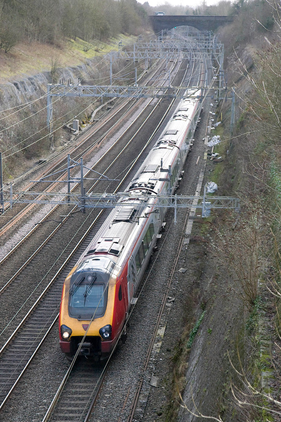 Class 221, VT 12.10 London Euston-Chester (1D86), Roade Cutting 
 An unidentified class 221 heads north through Road cutting forming the 12.10 London Euston to Chester working. The chances of ever identifying Voyager numbers is impossible, that id unless Virgin decide to place the numbers conspicuously on the the roof (like their Pendolino cousins). 
 Keywords: Class 221 12.10 London Euston-Chester 1D86 Roade Cutting