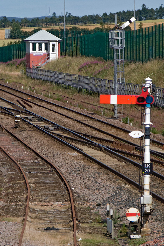 Laurencekirk signal box (Caledonian, 1910) 
 Laurencekirk signal box is a Caledonian Railway building dating from 1910 and contains a forty-lever frame. It stands around two hundred and fifty yards north of the station, on the east side of the line, and controls five semaphore arms and a number of disc shunt signals including three in a row on the down siding that unfortunately I did not capture during my visit. The box has had a fair amount of work done to 'improve' it including the very bright replacement roof! It is interesting to note the older and more traditional signal post compared with the more recent example installed by Network rail in recent years. 
 Keywords: Laurencekirk signal box Caledonian