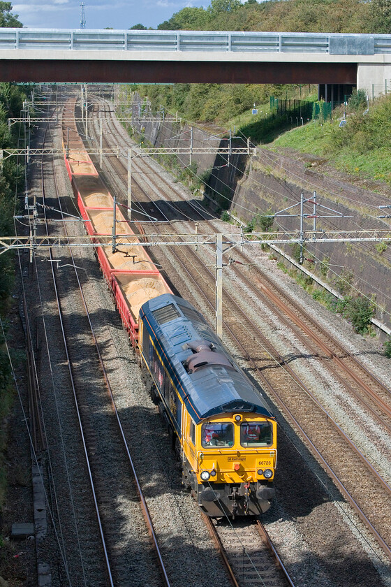 66725, 12.23 Bescot Yard-Wolverton (via Wembley) (6G55, 5E), Roade cutting 
 Due to this Saturday being another blighted by industrial action caused by both the employers and the unions not being capable of putting their heads together and thrash out some sort of agreement the fast lines of the WCML were put to other uses! The 6G55 12.23 Bescot Yard to Wolverton engineers' train passes through Roade cutting on the up fast line led by 66725 'Sunderland'. Despite leaving Bescot Yard over an hour after the previous infrastructure working it is now passing this same spot less than ten minutes after it such is the time saved by going on the fast via Weedon rather than the slow through Northampton. 
 Keywords: 66725 12.23 Bescot Yard-Wolverton via Wembley 6G55 Roade cutting Sunderland