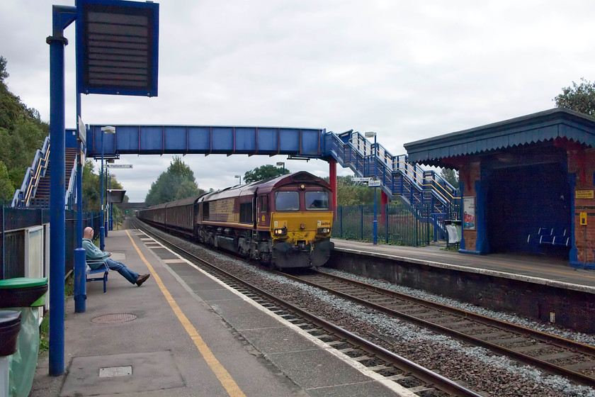 66004, 09.37 Dollands Moor-DIRFT via GWML & Birmingham (6M45), Kings Sutton station 
 A bit of a grab shot at King's Sutton station but a rare working for the Chiltern Line. Due to the closure of the WCML at Wembley for engineering works, freight was diverted. This is the daily Dollands Moor to Daventry Railfreight Depot 6M45 working that conveys thousands of litres of imported European bottled water. This train took a circuitous route from Kent to Northamptonshire via the cross-London Line to the GWML as far as Didcot, then up the Chiltern Line to Birmingham and then south down the WCML to Daventry. It seems a case of the 'water must get through'! 
 Keywords: 66004 09.37 Dollands Moor-DIRFT via GWML & Birmingham 6M45 Kings Sutton station