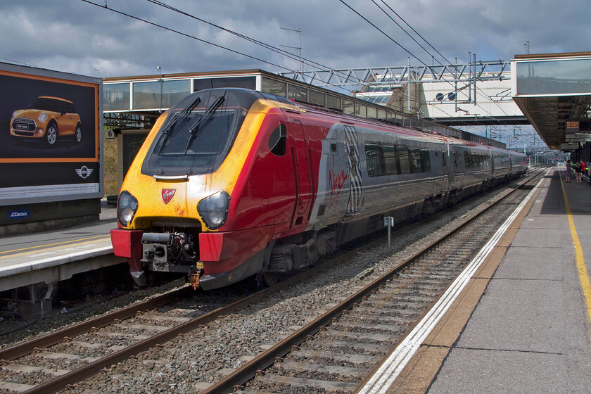 221107, VT 08.55 Holyhead-London Euston (1A23), Milton Keynes Central station 
 221107 comes to a halt at Milton Keynes station working the 1A23 08.55 Holyhead to Euston train. Looking at the very cloudy sky it appears that I have been very lucky to get the train in full sun even if this side of the Voyager is the wrong side for the sun! 
 Keywords: 221107 08.55 Holyhead-London Euston 1A23 Milton Keynes Central station Virgin West Coast Voyager.jpg