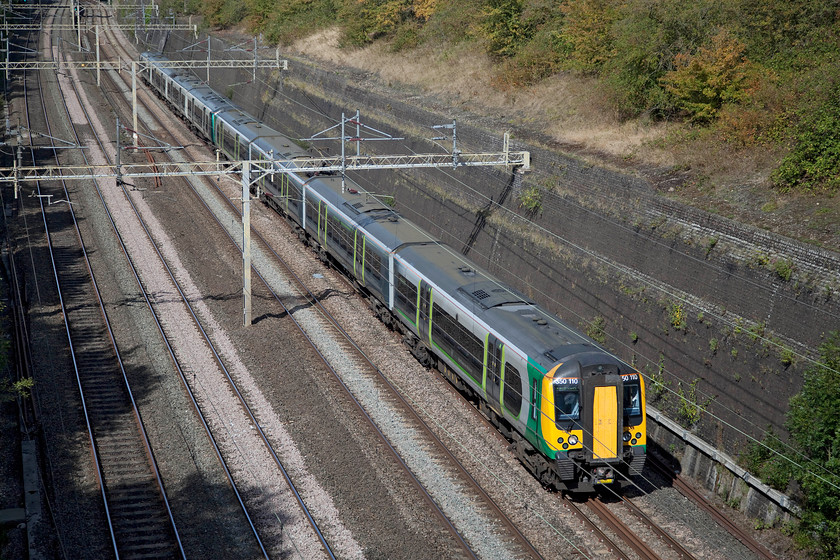 350110 & 350253, LN 12.17 Birmingham New Street-London Euston (2Y22, 2E), Roade cutting 
 An eight-car Desiro passes through Roade cutting working the 12.17 Birmingham New Street to Euston service. Catching plenty of autumn sunshine, 350110 leads 350253. 
 Keywords: 350110 350253 12.17 Birmingham New Street-London Euston 2Y22 Roade cutting