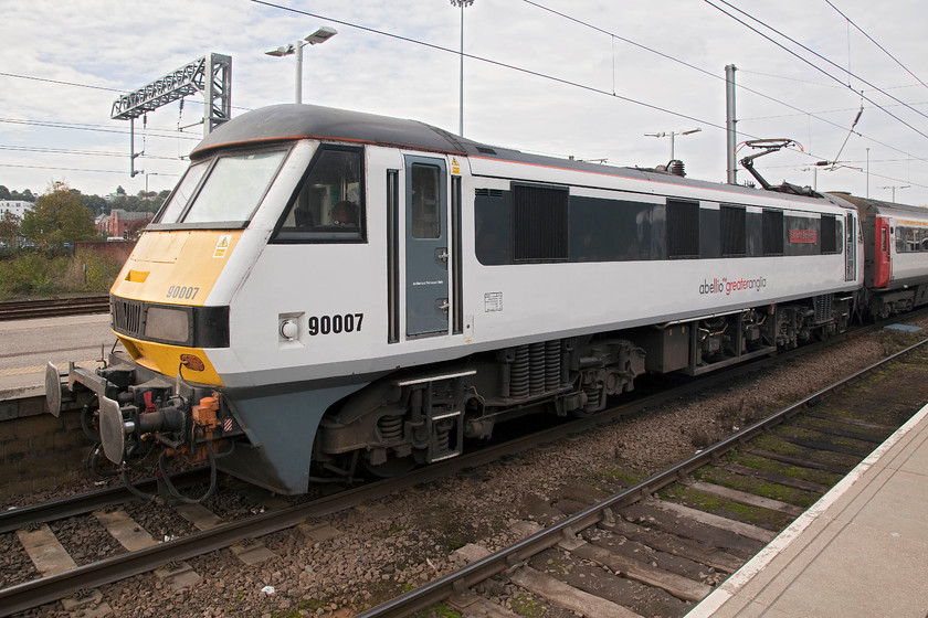 90007, LE 0012.0000 Norwich-London Liverpool Street (0001P0035), Norwich station 
 Greater Anglia's latest livery is this smart white and grey colour scheme. The branding includes the parent company's name Abellio that is itself owned by the Dutch state company Nederlandse Spoorwegen. I always think that liveries such as this look good when new and clean but they are a devil to keep clean during everyday running. 90007 'Sir John Betjeman' waits at Norwich to leave with the 12.00 to London Liverpool Street. 
 Keywords: 90007 12.00 Norwich-London Liverpool Street 1P35 Norwich station