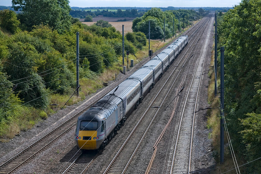 43251, GR 08.30 Edinburgh Waverley-London King's Cross (1E07), Westby SK962271 
 Now catching some sunshine the 08.30 Edinburgh to King's Cross gets into its stride as it descends Stoke bank near Westby. The rear power car is 43251 which originally carried the number 43051 that was part of set 253025 one of a later batch delivered to the Western Region in the late 1970s. 
 Keywords: 43251 08.30 Edinburgh Waverley-London King's Cross 1E07 Westby SK962271 East Coast HST