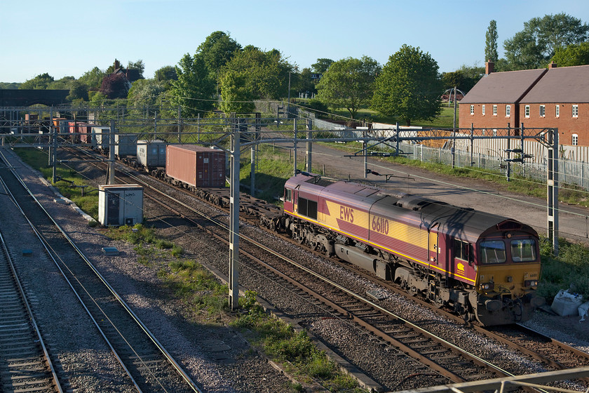 66110, 13.15 Trafford Park-London Gateway (4L56, 8E), site of Roade station 
 With the evening sun dipping low in the sky it creates long shadows but I really like conditions like this that create really warm and soft lighting. 66110 still wearing its EWS livery and three beasts branding passes Roade leading the 13.15 Trafford Park to London Gateway Freightliner. 
 Keywords: 66110 13.15 Trafford Park-London Gateway 4L56 site of Roade station EWS