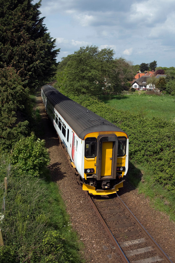 156407, LE 10.45 Norwich-Sheringham (2S14, RT), West Runton Station Road bridge 
 In lovey spring sunshine, 156497 leaves West Runton heading for its final station just a short distance away working the 10.45 Norwich to Sheringham. The picture is taken from Station Road bridge. 
 Keywords: 156407 2S14 West Runton Station Road bridge