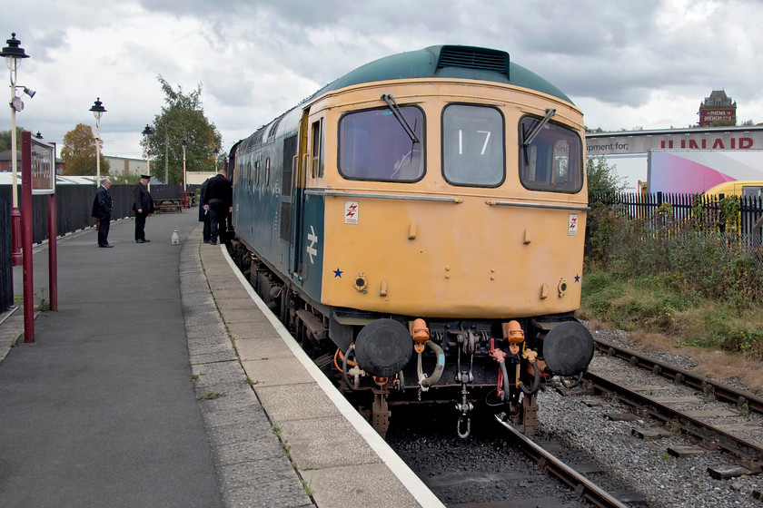 33035, 15.15 Heywood-Rawtenstall, Heywood station 
 33035 performed well on the ELR throughout the day and looked to be in good restored condition but for rather faded hi-viz. ends as seen here at Heywood station. I am about to join the train for the short trip back to Bury Bolton Street as the 15.15 to Rawtenstall, the final down train of the day. In the background is the tower of the now named Pheonix Brewery dating from 1898. This was Bass brewery up until closure in the 1980s with it being taken over by Pheonix in 1991. It is interesting that Heywood's Morrisons store, in a nod to the town's heritage, has built a central tower very similar to the brewery's but on a much smaller scale. 
 Keywords: 33035 15.15 Heywood-Rawtenstall Heywood station