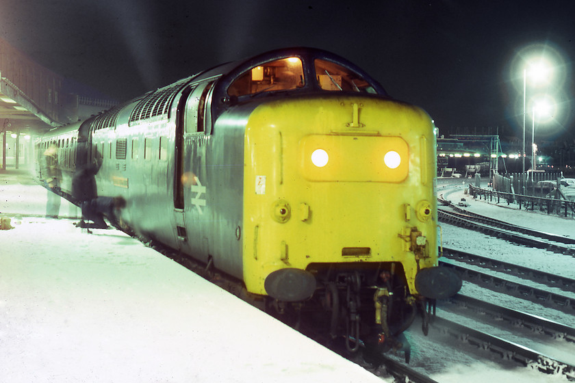 55016, 22.30 London King's-Cross-Edinburgh (1S72), York station 
 With three BR staff in attendance attempting to attach the water pipes and refill the steam heat boiler of 55016, Gordon Highlander at York. It was leading the 1S72 22.30 London King's Cross to Edinburgh. They eventually succeeded and got it the boiler filled and the train got on its way into the freezing December night. Gordon Highlander is still with us today being one of the chosen ones that entered preservation in October 1983. 
 Keywords: 55016 22.30 London King's-Cross-Edinburgh 1S72 York station Deltic Gordon Highlander