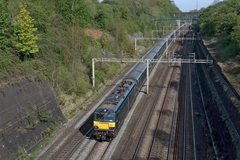 92038, CS 20.26 Inverness, 21.12 Aberdeen, 19.00 Fort William-London Euston (1M16, 189L), Roade cutting 
 It is rare to see the Caledonian Sleeper passing through Roade cutting at nearly ten o'clock in the morning. Usually, it passes just before seven. Due to a problem in the Borders in the middle of the night the 1M16, led by 92038, is running incredibly late. It eventually arrived at Euston well over three hours adrift but I am not too sure how many customers would have been inconvenienced with passenger numbers down ninety per cent due to the COVID-19 travel restrictions. 
 Keywords: 92038 20.26 Inverness 21.12 Aberdeen 19.00 Fort William-London Euston 1M16 Roade cutting Caledonian sleeper