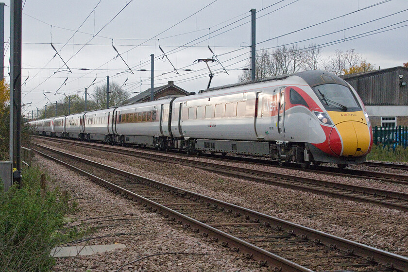 801108 & 800028, GR 08.33 London King's Cross-Leeds (1D06, RT), Tempsford level crossing 
 A small break in the unrelenting gloom allows just a little illumination on the flanks of 801108 and 800028 as it passes Tempsford. Andy and I had waited for this train as it was supposed to be part of a Class 225 Class 91 hauled digram. Not today though with passengers on board the 08.33 King's Cross to Leeds having to endure ironing board seating rather than a far more luxurious Mk. IV! 
 Keywords: 801108 800028 08.33 London King's Cross-Leeds 1D06 Tempsford level crossing LNER Azuma