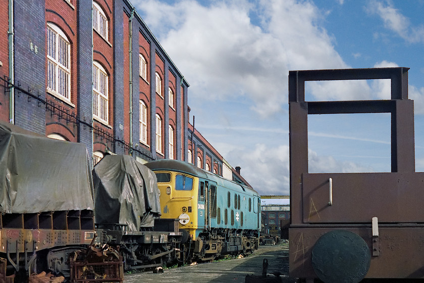 24084, awaiting scrapping, Swindon Works 
 24084 is well away from the rest of the withdrawn locomotives at Swindon Works. It was almost like it was being kept safe in readiness for a preservation bid. Sadly, this did not happen and it went the way of the rest of the class 24s at Swindon. Just to the right of the picture is the GWML and this 24, along with a number of other locos, was in full view of the passing trains.