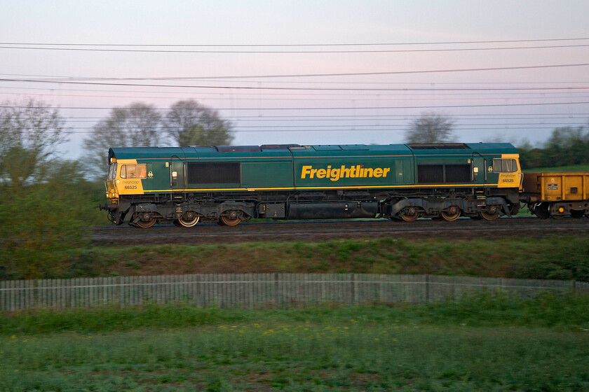 66525, 02.43 Crewe Basford Hall-Bletchley flyover (6Y52, 4L), between Roade & Ashton 
 Taken at 05.26 on the third day of May meant that the lighting was a little marginal, to say the least for this photograph! I had to resort to a slow shutter speed and a pan shot to capture the 6Y52 02.43 Crewe Basford Hall to Bletchley flyover infrastructure working. There are some regular workings now heading over the refurbished flyover at Bletchley and then heading off down the newly reinstated East-West railway towards Winslow and Bicester. However, they do tend to run at some awkward times such as this particular one. 
 Keywords: 66525 02.43 Crewe Basford Hall-Bletchley flyover 6Y52 between Roade & Ashton Freightliner