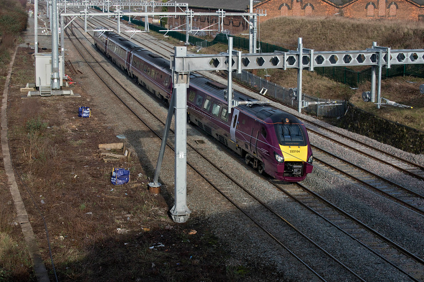 222104, EM 12.12 Nottingham-London St. Pancras (1B41, 10L), Mill Road bridge 
 Taken from the well-known spot at Mill Road bridge just north of Wellingborough station 222104 slows for its stop at the station forming the 12.12 Nottingham to St. Pancras. This is my first sight of a Meridian in its new East Midlands Railway livery. I am not sure about the purple paint scheme, thinking that it looks a little dour; I'll let you decide! Notice the former Wellingborough steam shed in the background. This is currently being converted into an Aldi supermarket but work has slowed recently due to issues with asbestos. 
 Keywords: 222104 12.12 Nottingham-London St. Pancras 1B41 Mill Road bridge Wellinbgborough Meridian EMR East Midlands Railway