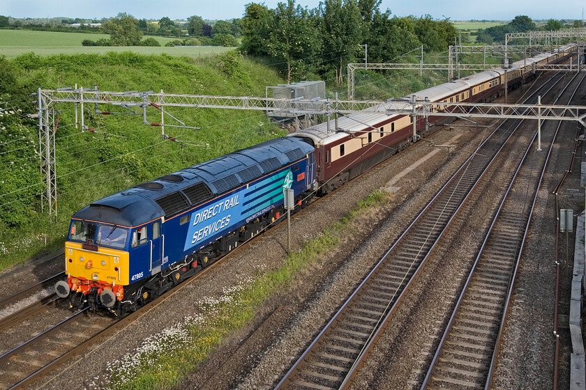 47805, Willesdon Yard-Milton Keynes Central-Northampton-Birmingham New Street Silverstone GP Special (1Z36), Victoria bridge 
 In glorious evening light 47805 'John Scott 12.5.45-22.5.12' leads the returning Grand Prix charter past Victoria bridge near Roade. Running as 1Z36 it left Willesden Yard stopping at Milton Keynes and Northampton to collect passengers. 47805, with 47832 'Solway Princess' on the rear, then continued on to Birmingham where it reversed to head back to Euston. F1 fans on board would have been disappointed having seen British hopes in the form of Lewis Hamilton come in fourth after having tyre issues. 
 Keywords: John Scott 12.5.45-22.5.12 47805 Willesdon Yard-Milton Keynes Central-Northampton-Birmingham New Street Silverstone GP Special 1Z36 Victoria bridge