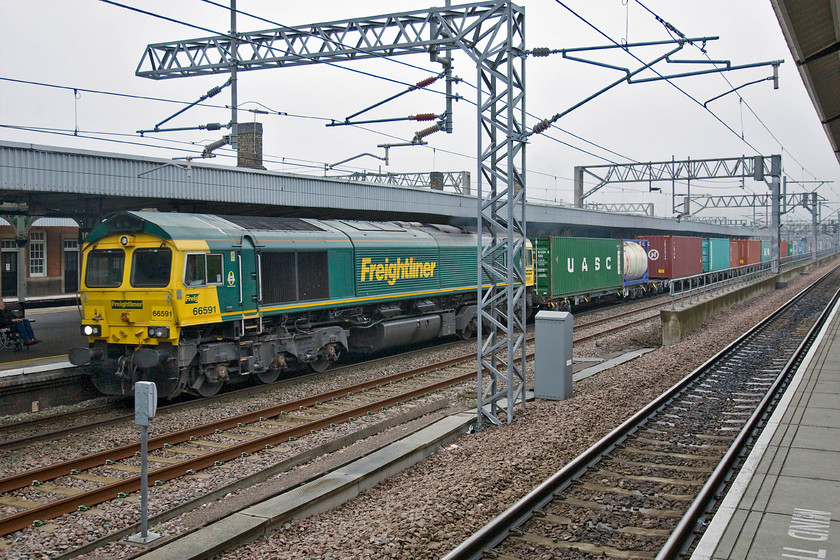 66591, 08.50 Crewe Basford Hall-Felixstowe North, Nuneaton station 
 Since the extensive reconfiguration of Nuneaton station a few years ago, the slightly elevated platforms six and seven give a reasonable view of the up slow line. 66591 runs at full line speed through platform five leading Freightliner's 08.50 Crewe Basford Hall to Felixstowe service. 
 Keywords: 66591 08.50 Crewe Basford Hall-Felixstowe North Nuneaton station Freightliner