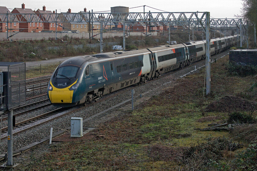 390002, VT 11.33 London Euston-Liverpool Lime Street (1F18, 2E), site of Roade station 
 390002 'Stephen Sutton' heads past the site of Roade's former station working the 11.33 Euston to Liverpool Lime Street train. I was getting concerned that vegetation re-growth in the foreground was getting a little out of control and that this excellent spot to take photographs of down services would become problematic again. However, as can be seen here, contractors have once again cleared the greenery thus enabling a clear view for a couple more years at least. 
 Keywords: 390002 11.33 London Euston-Liverpool Lime Street 1F18 site of Roade station Stephen Sutton