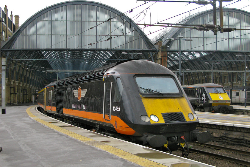 43465, GC 12.53 London King`s Cross-Sunderland (1N93) & 91110, GR, 06.50 Glasgow Central-London King`s Cross (1E06), London King`s Cross station 
 I like the style of the open access operator Grand Central, they have a certain flair and have fought hard for every passenger. Now they have broadened their operations building on their success and operate a number of services to and from the northeast and West Yorkshire. They operate some HSTs and class 180s, both cast-offs from other TOCs. Here at King's Cross, buffer beam 43465 leaves with the 12.53 to Sunderland. In the background, 91110 'Battle of Britain Memorial Flight' has recently arrived propelling the 06.50 from Glasgow central. 
 Keywords: 43465 12.53 London King`s Cross-Sunderland 1N93 91110 06.50 Glasgow Central-London King`s Cross 1E06 London King`s Cross station Grand Centra HST Battle of Britain Memorial Flight