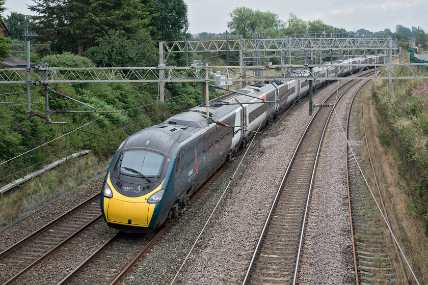 390103, VT 09.10 London Euston-Glasgow Central (1A48, 2E), Norton Bridge SJ869302 
 390103 passes Norton Bridge working Avantis 09.10 Euston to Glasgow Central service. It has just crossed the flat junction that was once the cause of so many conflicting train movements until the brand new and ambitious remodelling of this section of line was completed in 2016. Indeed, the line that is now the up fast route can be seen joining to the top left of the photograph 
 Keywords: 390103 09.10 London Euston-Glasgow Central 1A48 Norton Bridge SJ869302 Avanti West Coast Pendolino