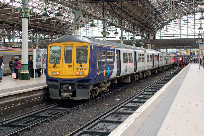 319385, NT 11.58 Crewe-Manchester Piccadilly (2H43, 4L), Manchester Piccadilly station 
 319385 has just arrived at Manchester Piccadilly with the 11.58 from Crewe whilst passengers on the adjacent platform four are kept waiting to board a CrossCountry Voyager. These former Thameslink class 319s must represent a significant improvement for passengers in this area with them having undergone a full overhaul. They are spacious and comfortable, far more so than the class 700 units now on the Bedford to London services! 
 Keywords: 319385 11.58 Crewe-Manchester Piccadilly 2H43 Manchester Piccadilly station