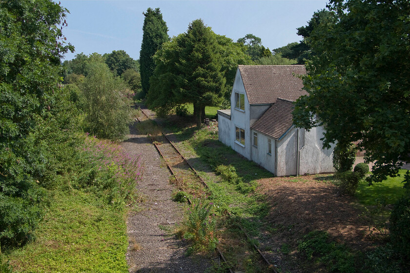 Trackbed & former station building Hammerwich SK074071 
 Without the presence of the track, one would not identify the building as a former station. Hammerwich station closed to passengers in January 1965 when the direct line from Wichnor Junction to Walsall had its passenger services withdrawn. Through freight traffic continued until 1984 when the line was truncated at the Charrington's oil depot located at Brownhills. There is a superb period piece of film taken from the cab of a down freight traversing the line with Hammerwich station being passed at 8m 43s, see..... https://www.youtube.com/watch?v=3XkUnkrl6oU&t=531s Indeed the broad balck country accented driver is heard to say 'old station, Hammerwich' as they pass the building! 
 Keywords: Trackbed & former station building Hammerwich SK074071 South Staffordshire Line.