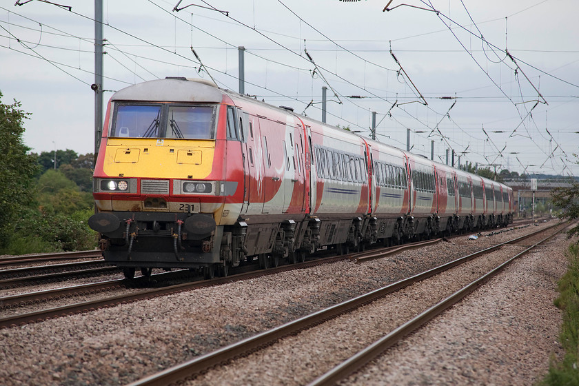 82231 & 91130, GR 08.45 Leeds-London Kings Cross (1A18, 3L), Holme Green Crossing TL192426 
 DVT 82231 leads the 08.45 Leeds to King's Cross with 91130 'Lord Mayor of Newcastle' providing the power at the rear. The train is seen passing Holme Green farm crossing just south of Biggleswade, indeed in this picture taken with my Sigma 80-200 zoom, the A1 road bridge to the south of the town can be seen. 
 Keywords: 82231 91130 1A18 Holme Green Crossing TL192426