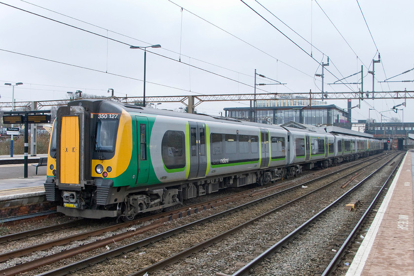 350127, LM 10.33 Birmingham New Street-London Euston (1W10), Northampton station 
 350127 is seen in this image at the rear of the 10.38 Birmingham New Street to Euston at Northampton station. The new building, that opened last month (February 2015) is seen above the front of the train. 
 Keywords: 350127 10.33 Birmingham New Street-London Euston 1W10 Northampton station